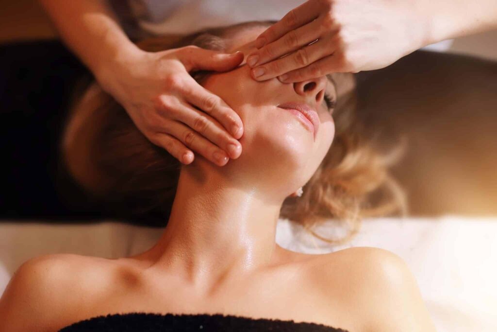 happy-woman-having-face-massage-in-spa-salon-BB2ASVD.jpg